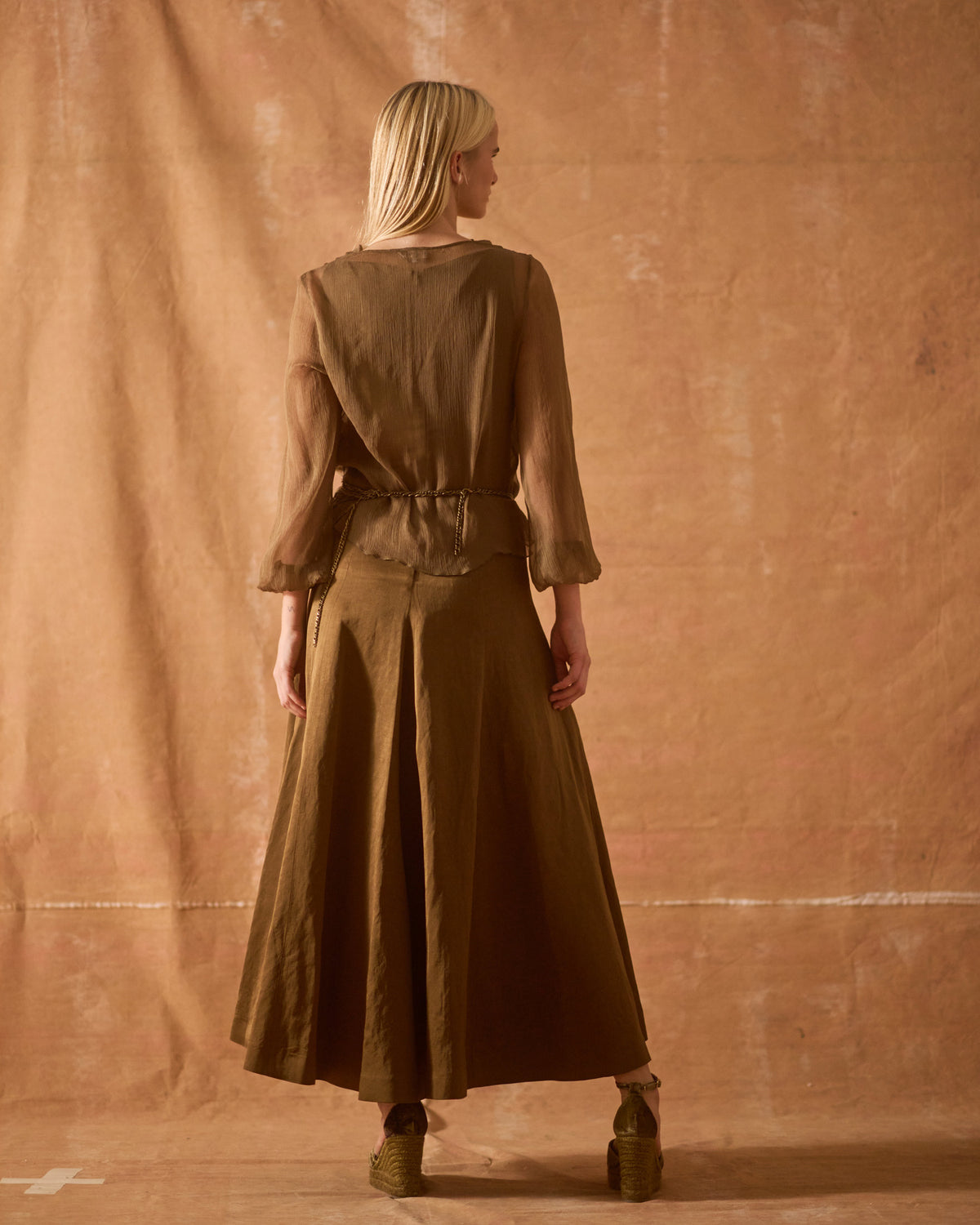 Back view of model wearing Chiara wedge espadrilles in printed mocca silk velvet with ankle straps T.ba