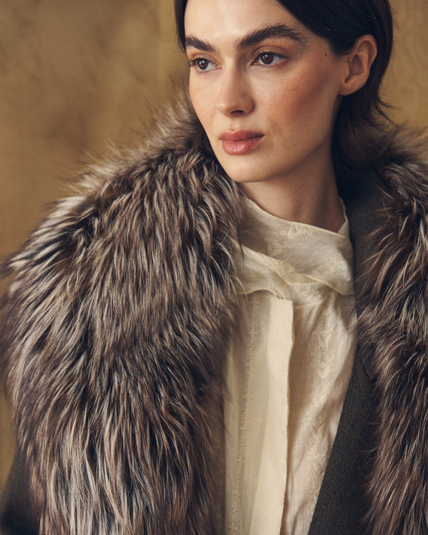 Close-up shot showing texture of the Baltea soft faux fur collar in brown and grey tones by T.ba
