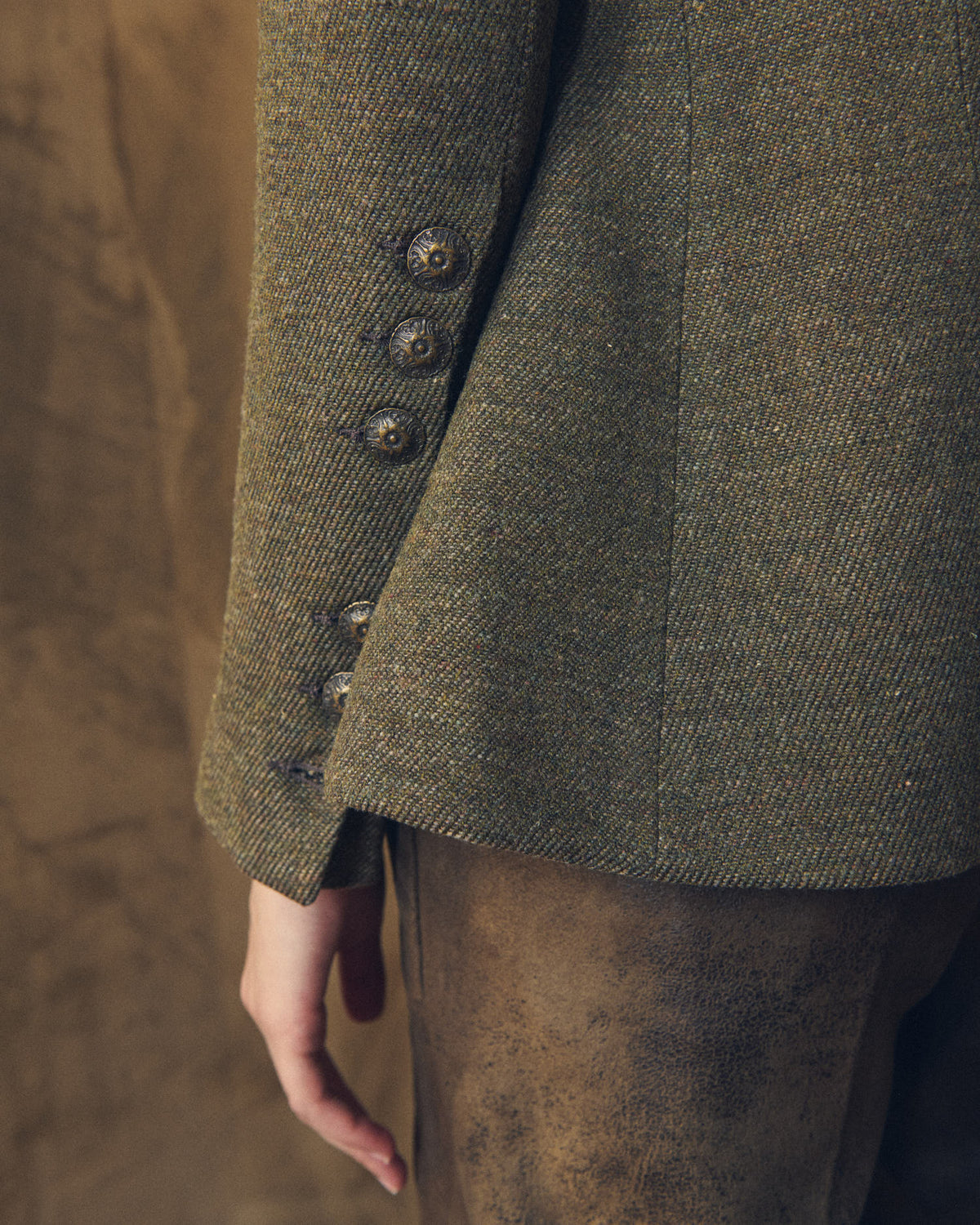 Detail of the sleeve cuff on the Baltea Tweed jacket with ornate brass buttons by T.ba