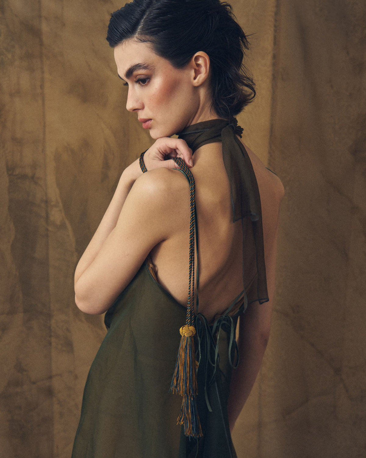 Detail back view of model wearing the open-back Biella long organza dress with delicate thin straps by T.ba