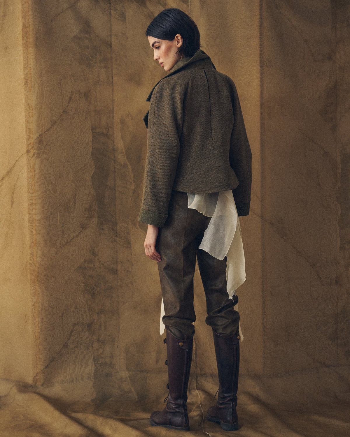 Back view of the Biella bomber jacket in khaki tweed wool featuring a inverted back pleat for women T.ba