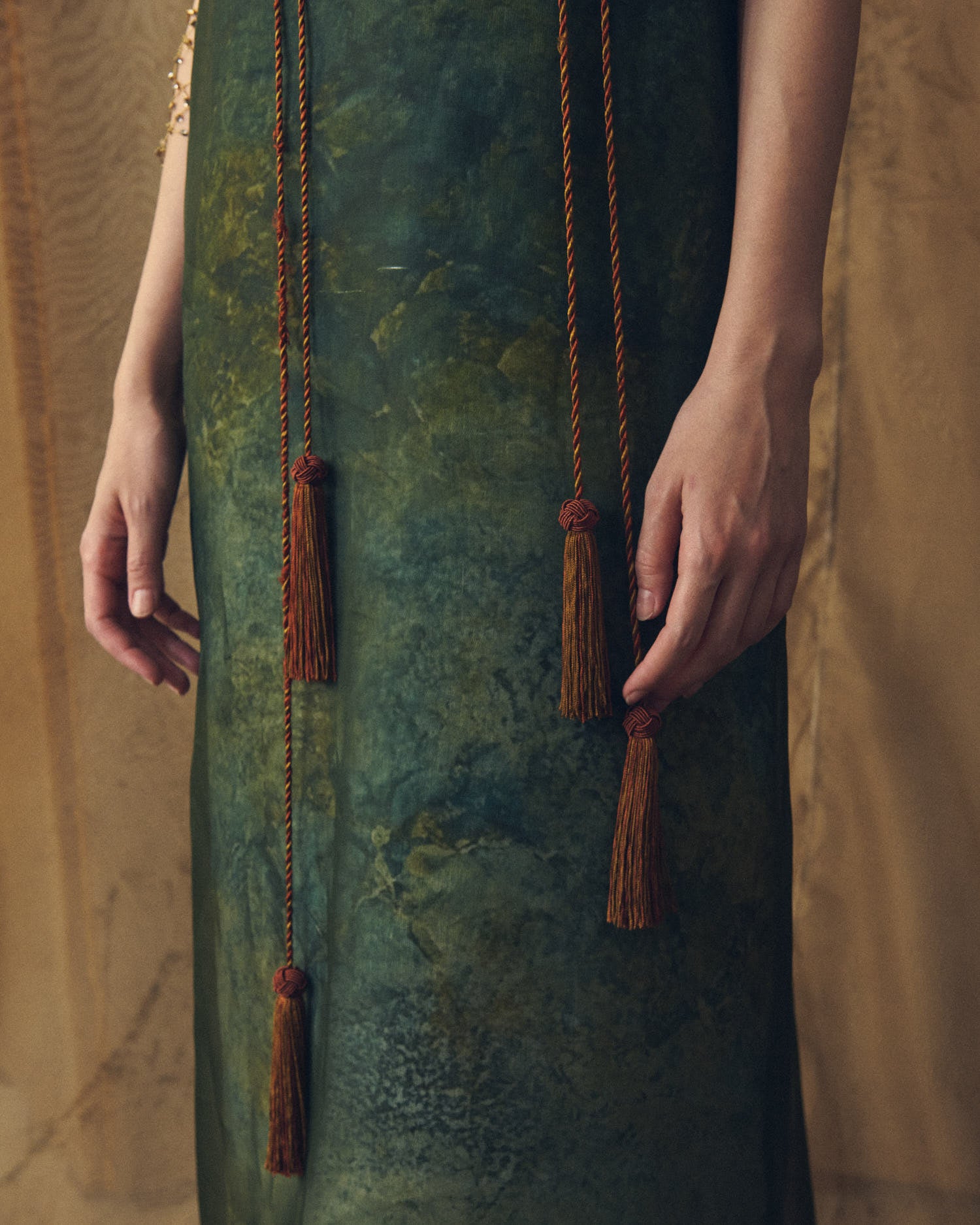 Close-up detail of hanging cord tassels and hand-dyed organza texture on the Birdie long dress for women by T.ba