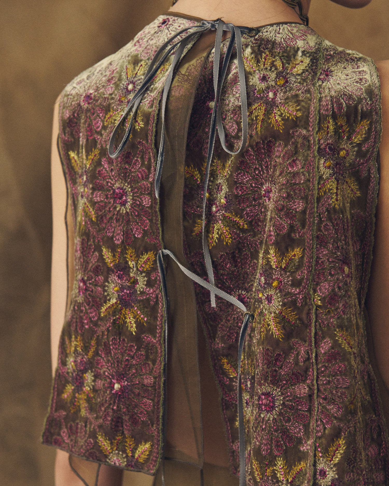 Close-up back view of the Carlo top in aubergine and green embroidered velvet featuring thin ribbon fastenings by T.ba