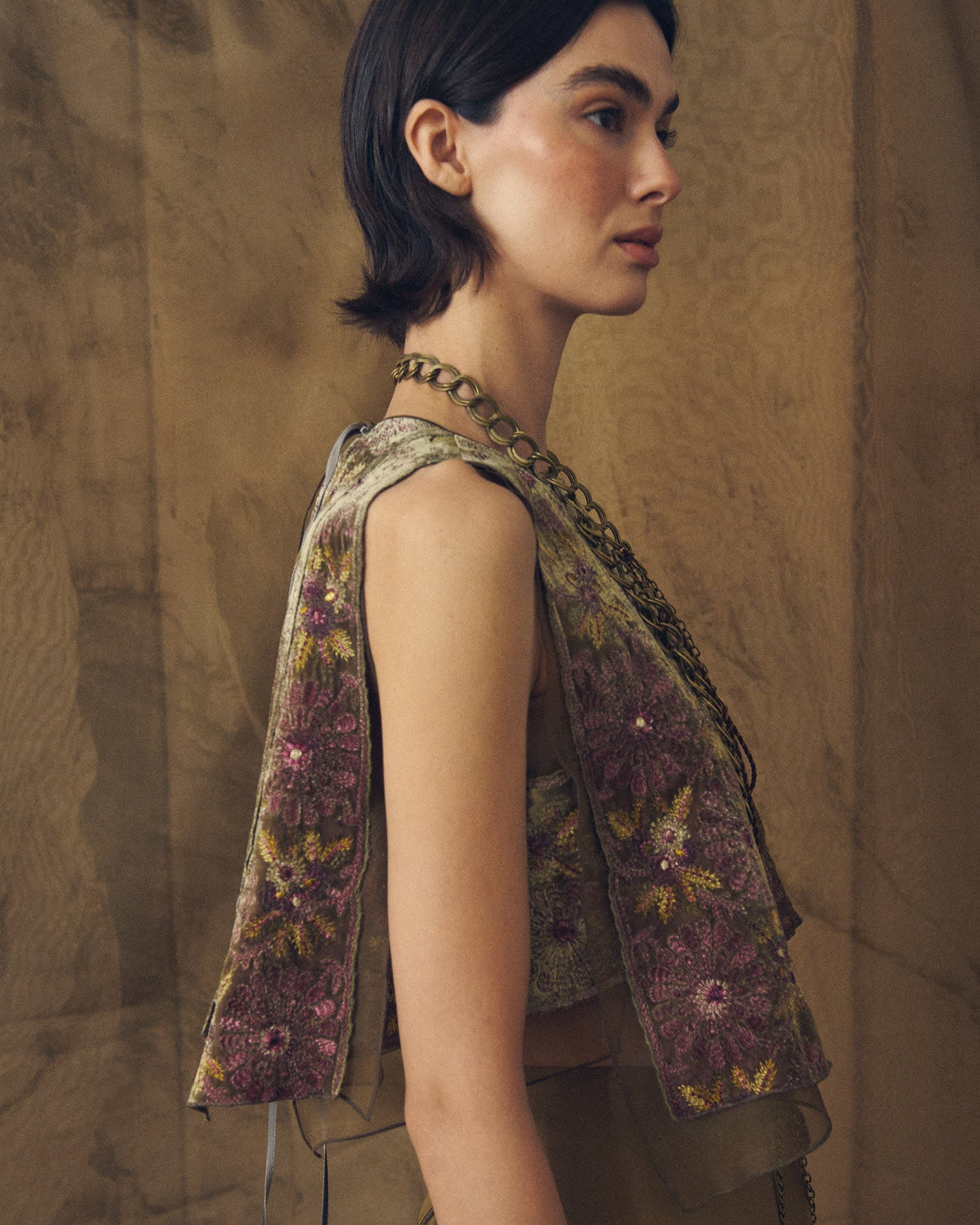 Side profile shot showing the sheer organza layers and embroidered velvet panels of the Carlo top by T.ba