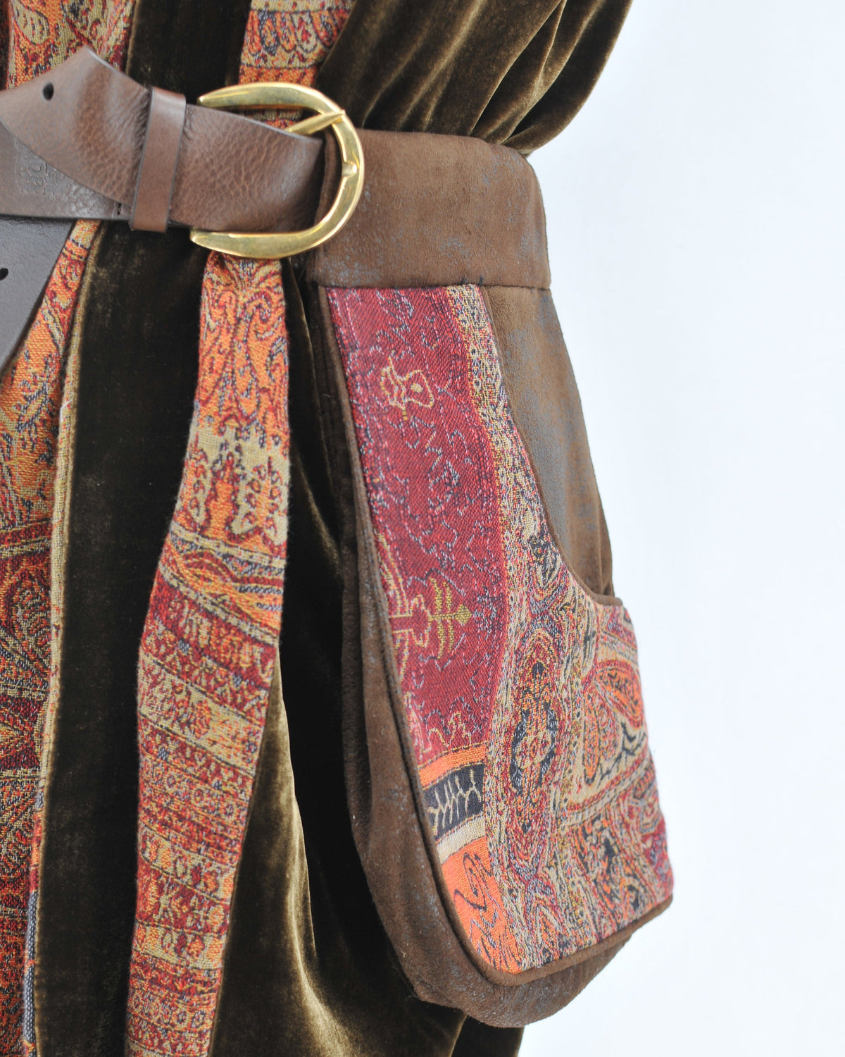 Detailed close-up shot of brown leather Duke belt pouch featuring jacquard tapestry pocket and brass buckle T.ba