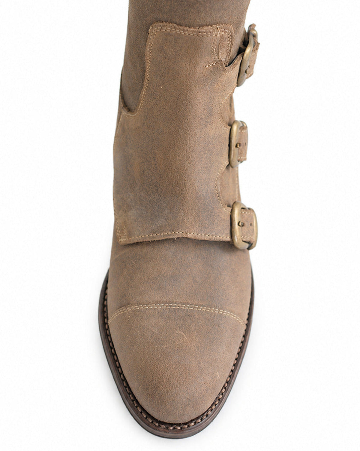 Detailed close-up view of beige suede Buckle Boots with antique brass buckles and stitched toe cap for women T.ba