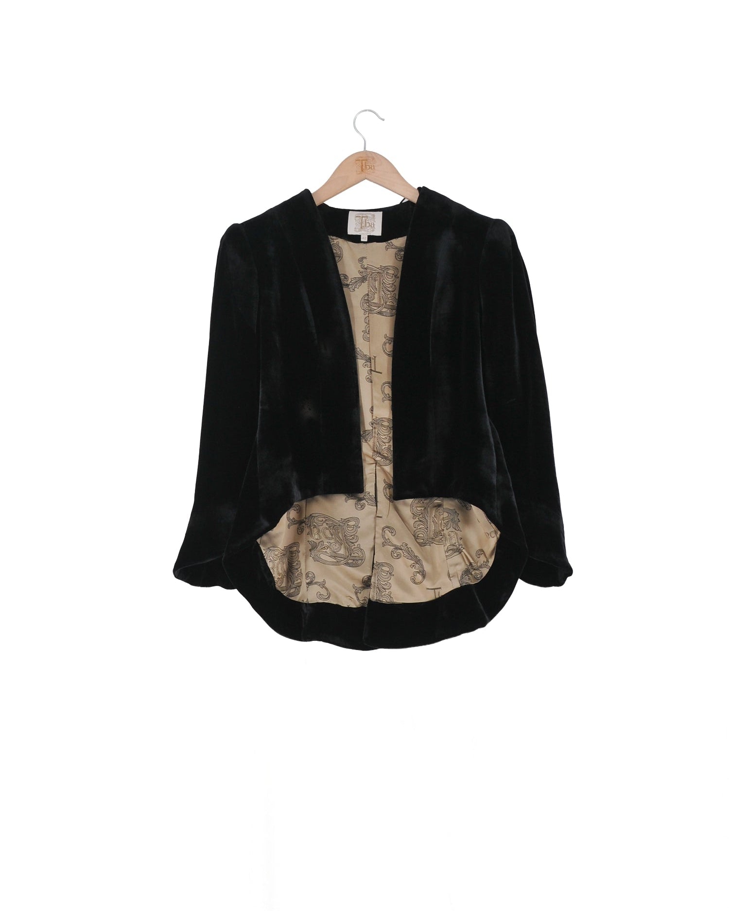 Front studio view on hanger of the Daria short jacket in black silk velvet with patterned lining by T.ba