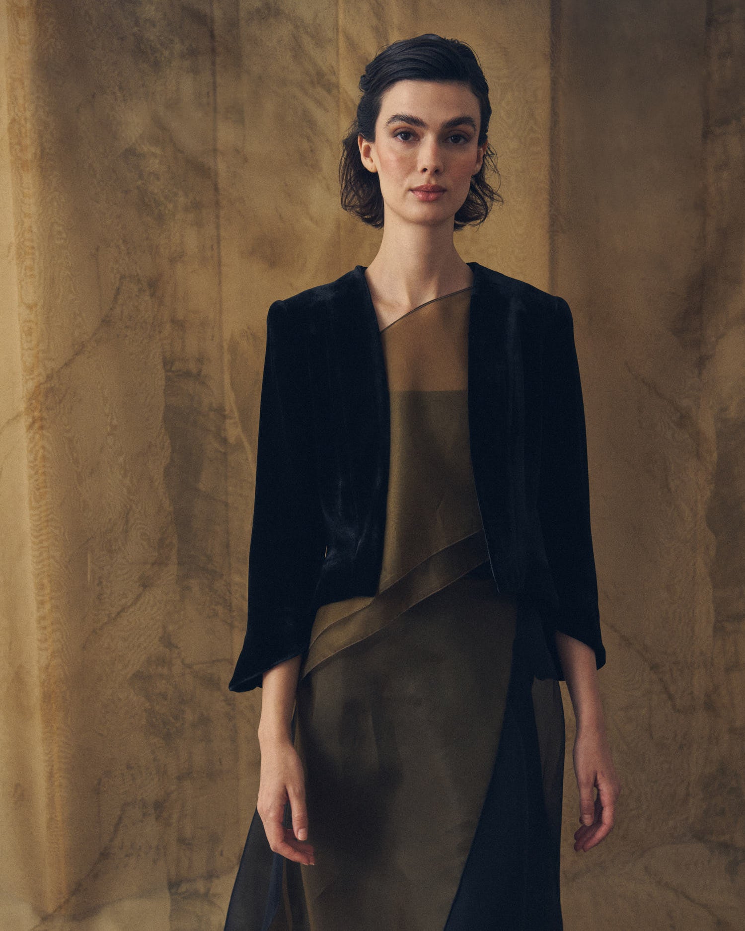 Medium shot of model wearing the open-front Daria jacket in black silk velvet by T.ba
