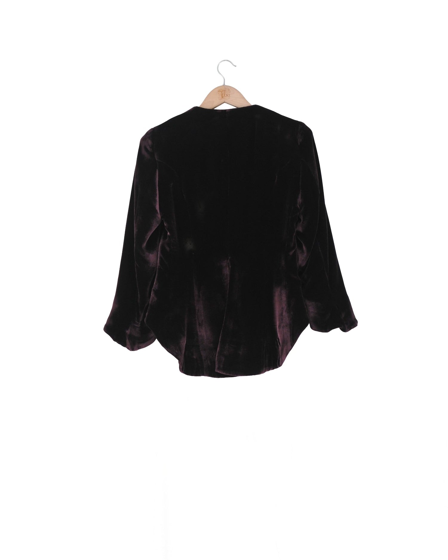 Back studio view on hanger of the Daria cropped silk velvet jacket in deep grape by T.ba
