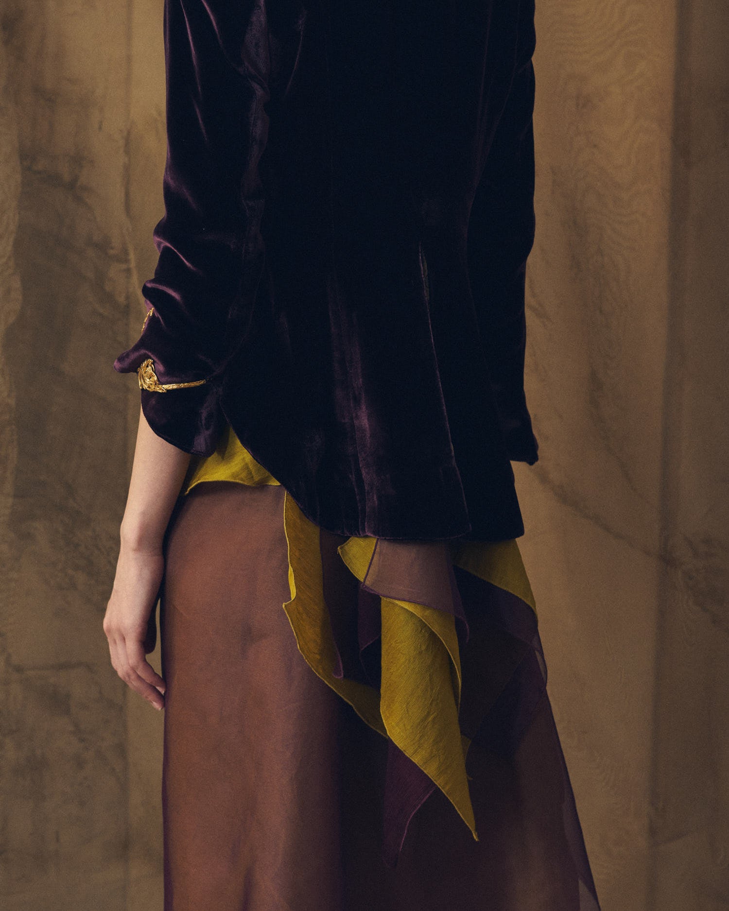 Close-up back view of the Daria jacket in grape silk velvet highlighting the high-low hem and gold cuff detail by T.ba