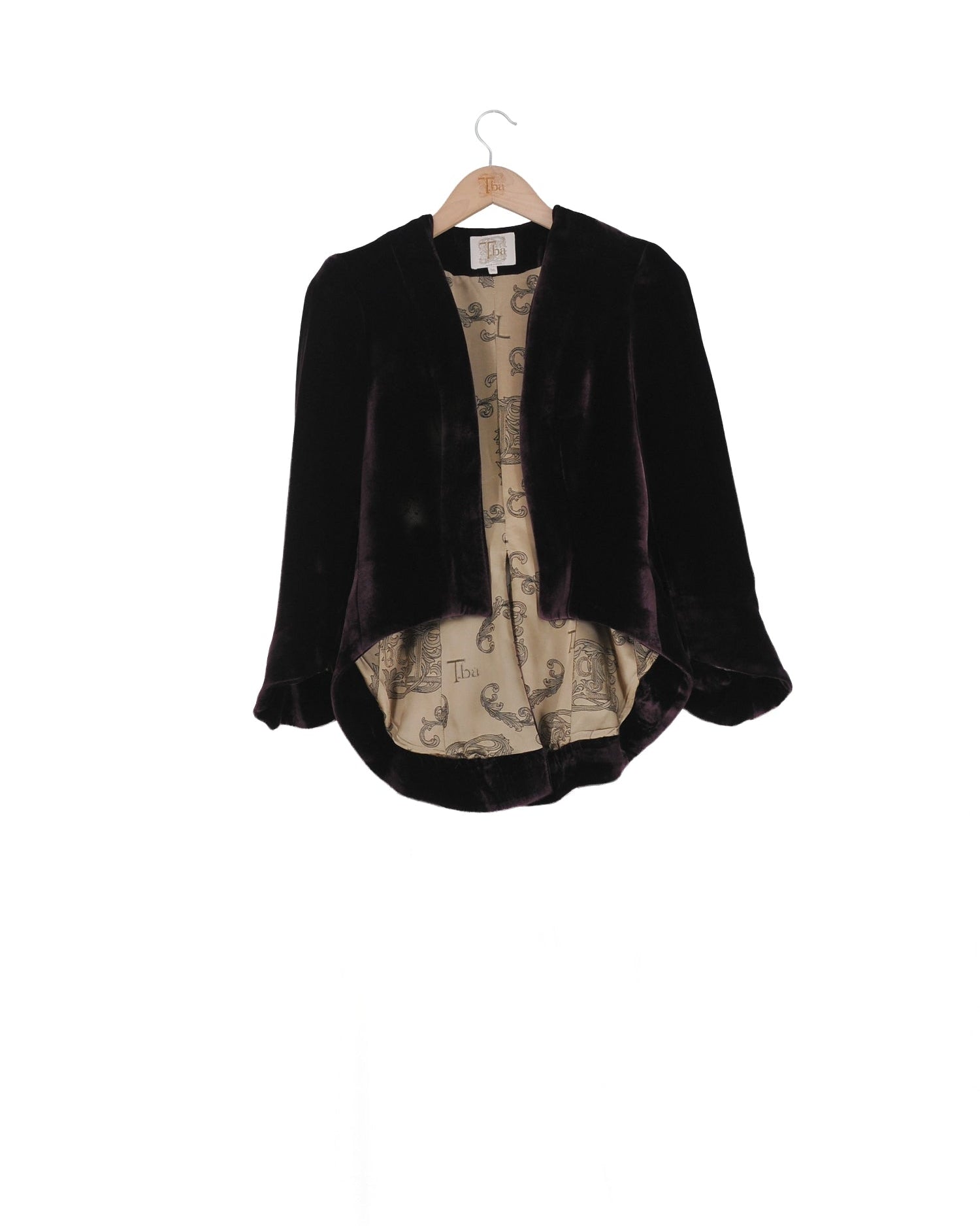 Front studio view on hanger of the Daria short jacket in grape silk velvet with patterned silk lining by T.ba