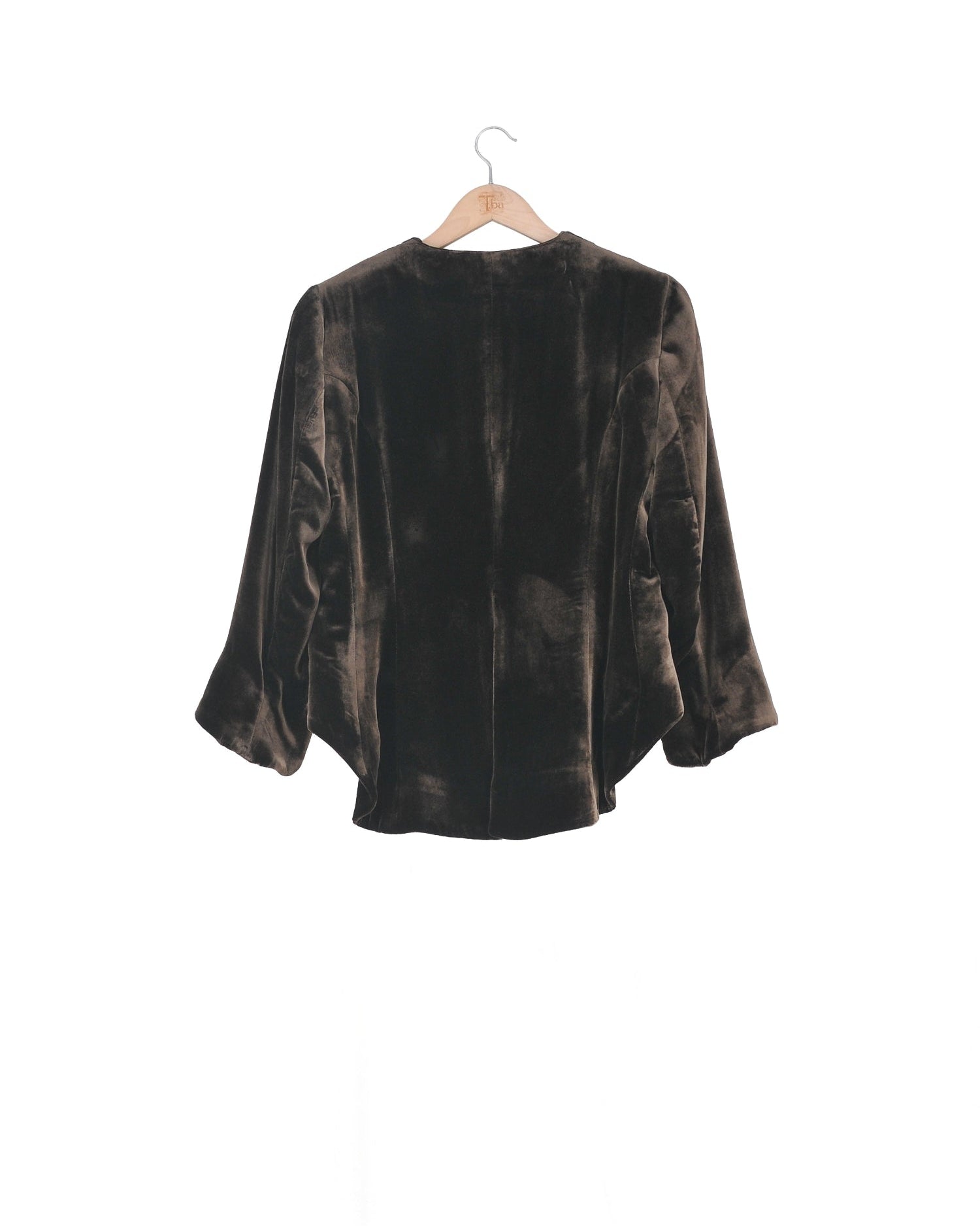 Back studio view on hanger of the Daria short silk velvet jacket in truffle brown by T.ba