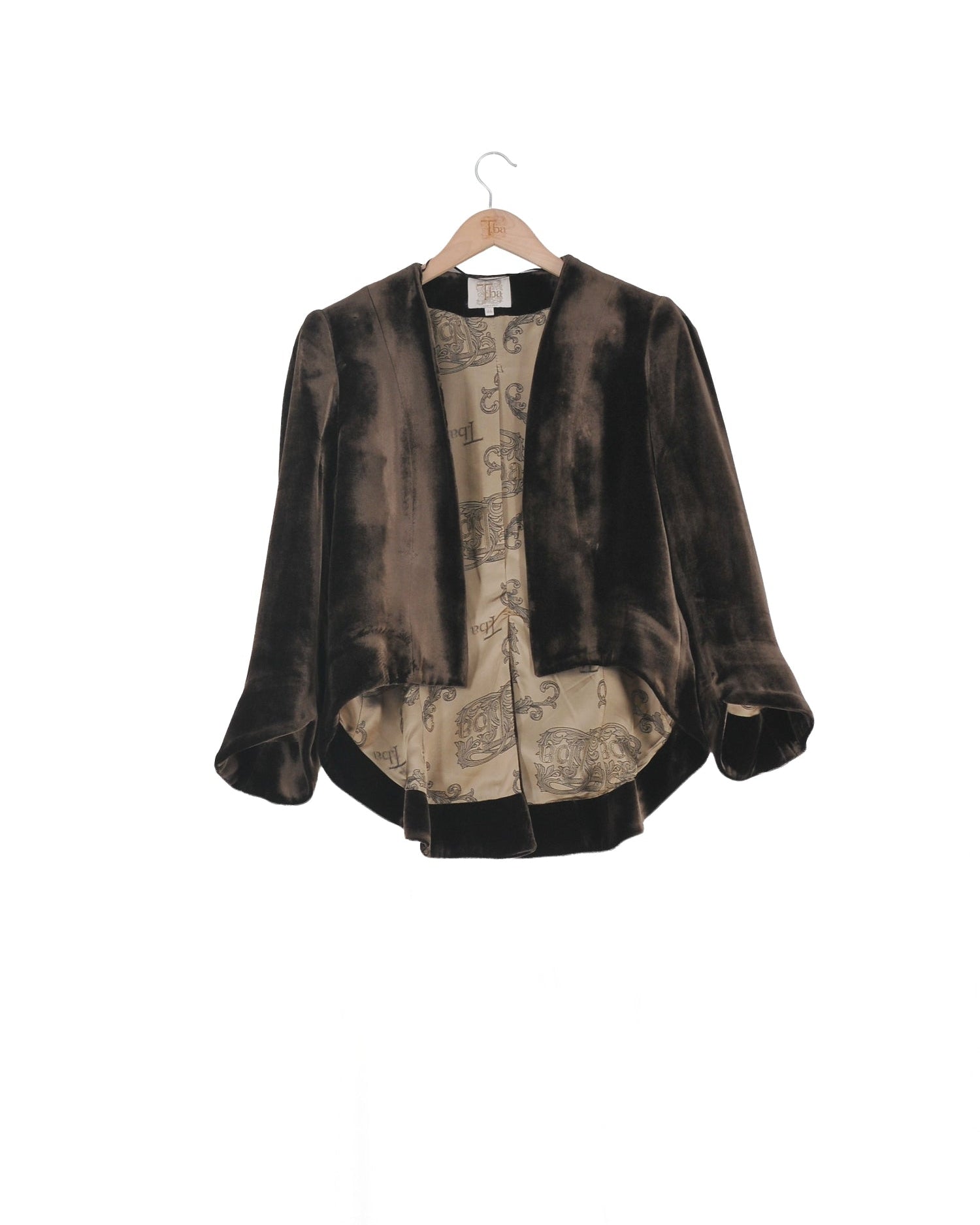 Front studio view on hanger of the Daria short jacket in truffle silk velvet featuring printed lining by T.ba