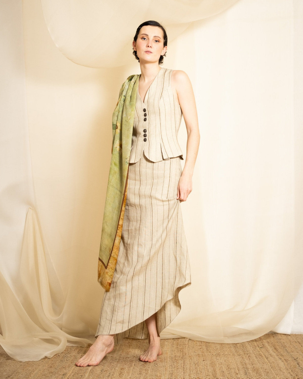 Model wearing Greta printed wool shawl draped over shoulder with cream linen set for women T.ba