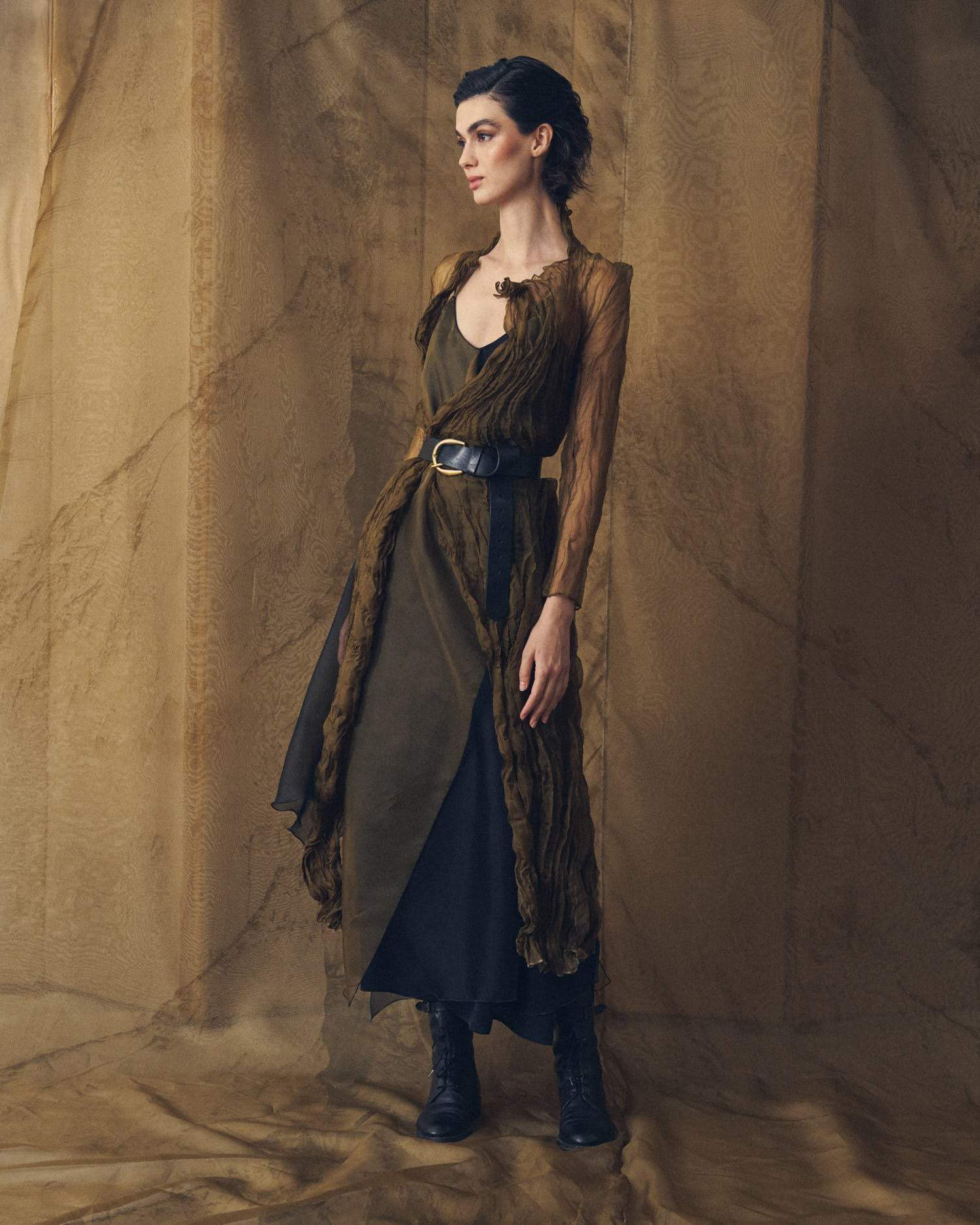 Full length shot of model wearing the Duke Belt wide black leather belt styled over a flowing silk dress for women by T.ba