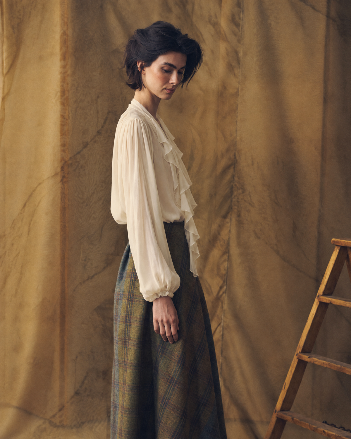 Three-quarter side profile view of model wearing the long sleeve Fine Crepe Pienza Blouse in natural crepe with elasticated cuffs for women by T.ba