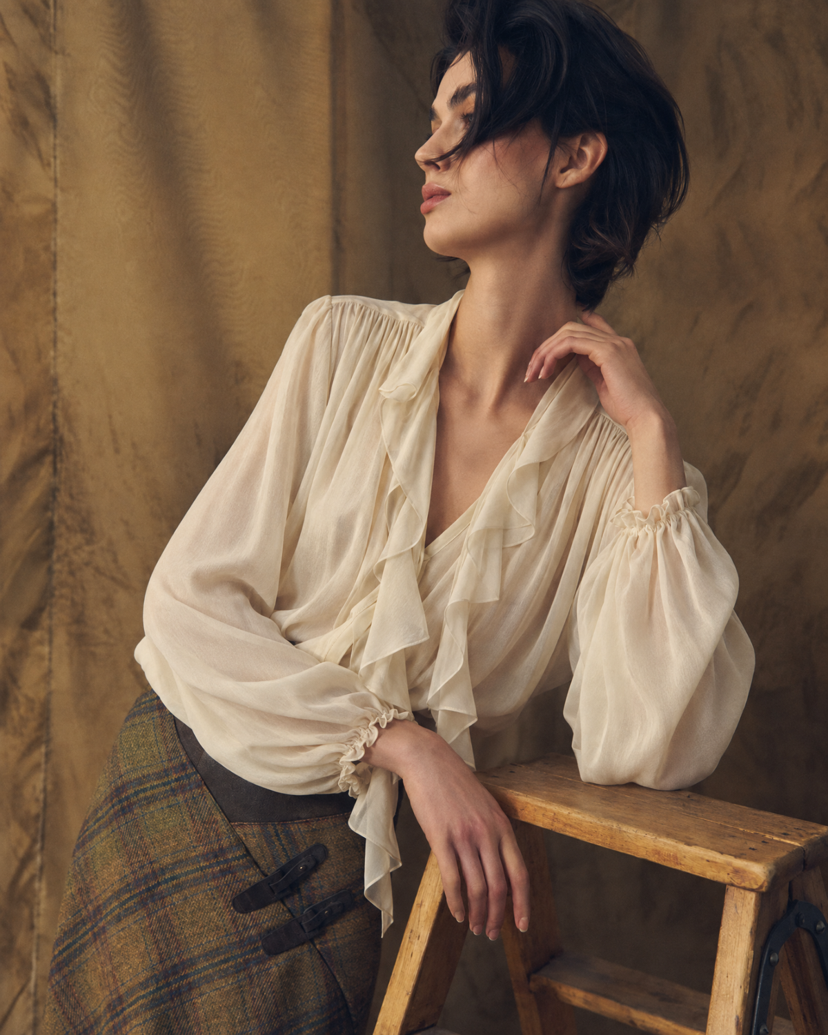 Medium close-up view highlighting the open V-neckline and delicate ruffles of the Fine Crepe Pienza Blouse in natural silk crepe for women by T.ba