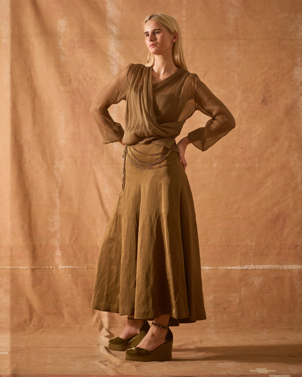 Model wearing Chiara printed mocca silk velvet wedge espadrilles paired with silk blouse and midi skirt for women T.ba