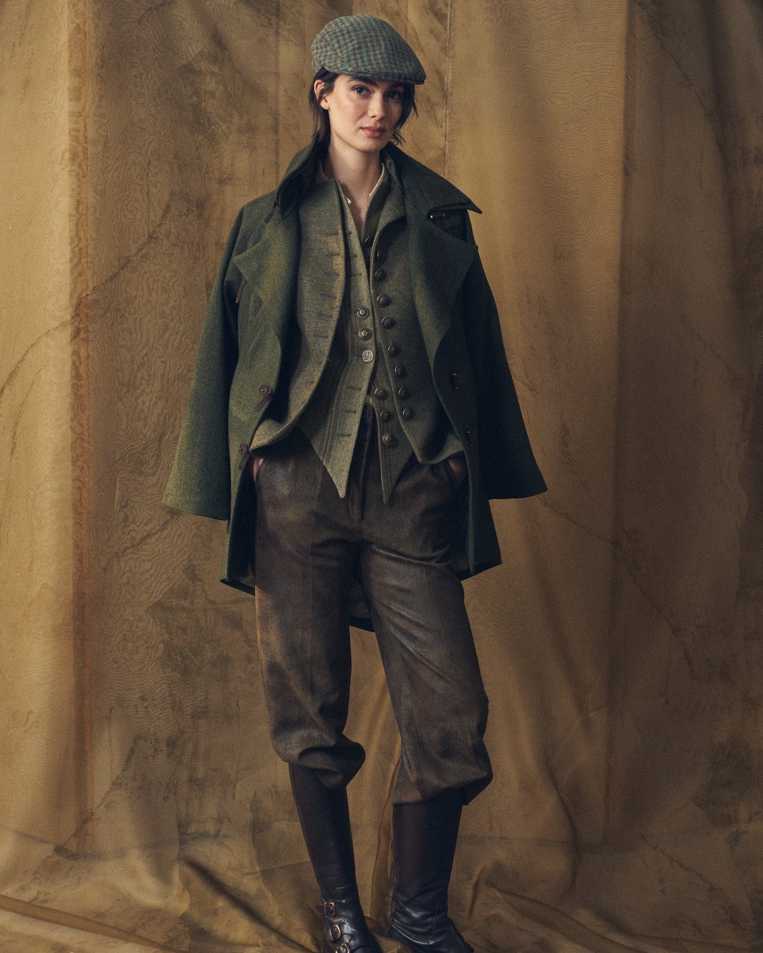 Front full-length view of the Jerez Biella Field Coat in hunting green wool tweed worn over a matching waistcoat and trousers for women by T.ba.
