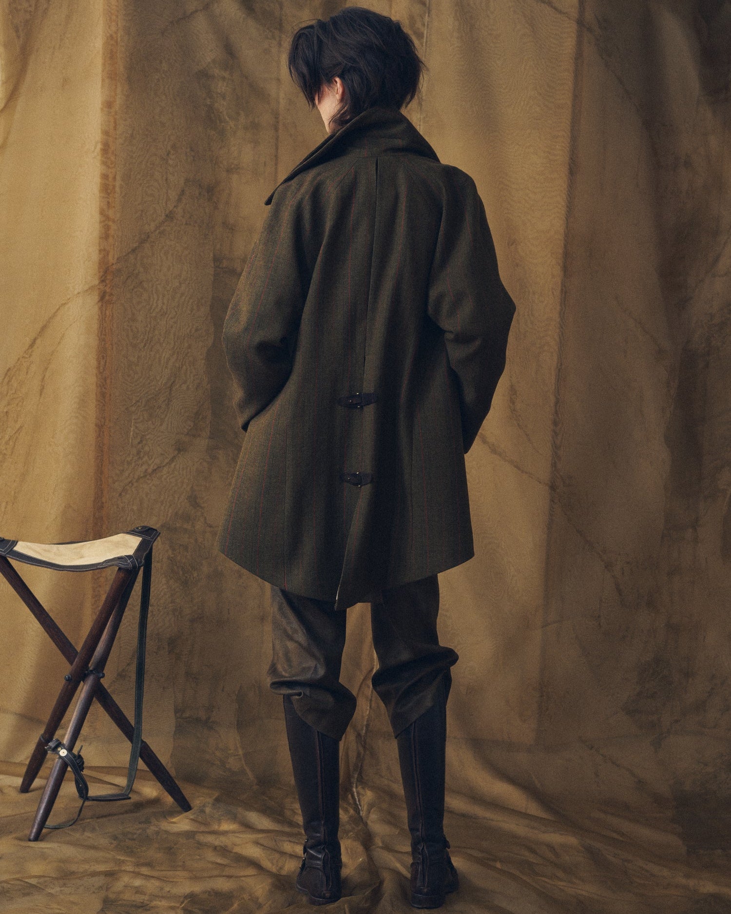Full back view of the Jerez Biella Field Coat in khaki wool tweed with red pinstripes and rear buckle straps for women by T.ba.