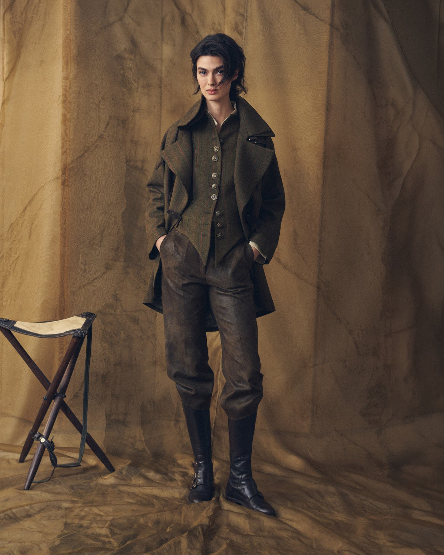 Full-length look featuring the Jerez Knit Short Baltea Vest in green pinstripe wool over a white blouse and paired with brown leather trousers, complete with a matching jacket and riding boots for women T.ba.