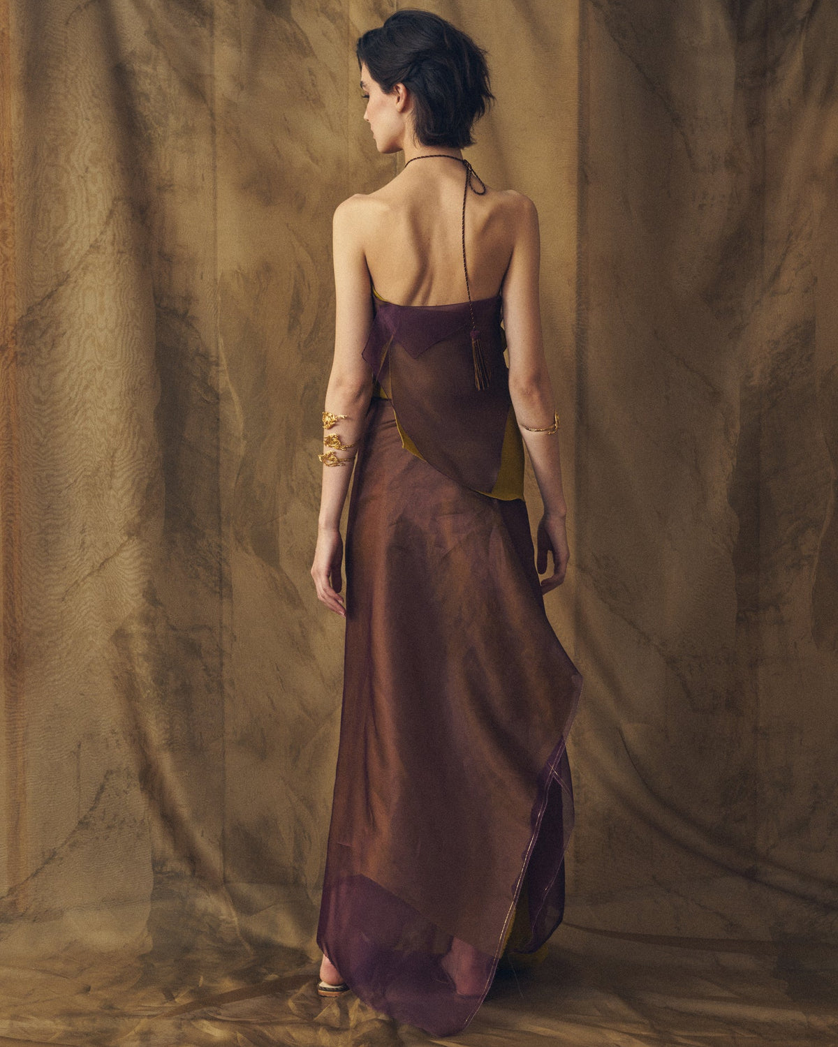 Back view of women's Organza Panarea sheer aubergine and arbequina skirt showing flowing silhouette and yellow accents by T.ba