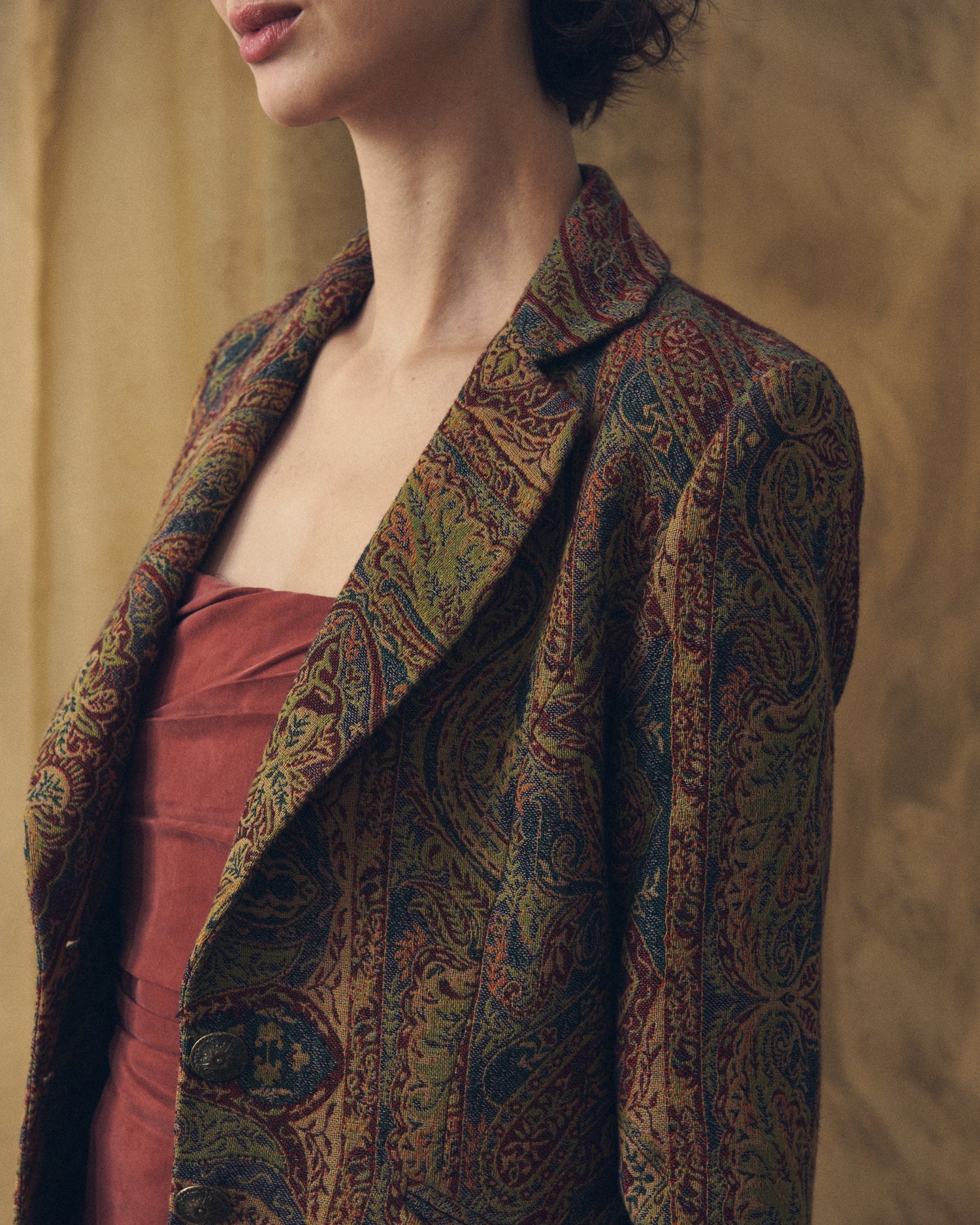 Close-up front view of women's Jacquard Lancelot coat featuring notch lapel, metal buttons, and paisley jacquard pattern by T.ba