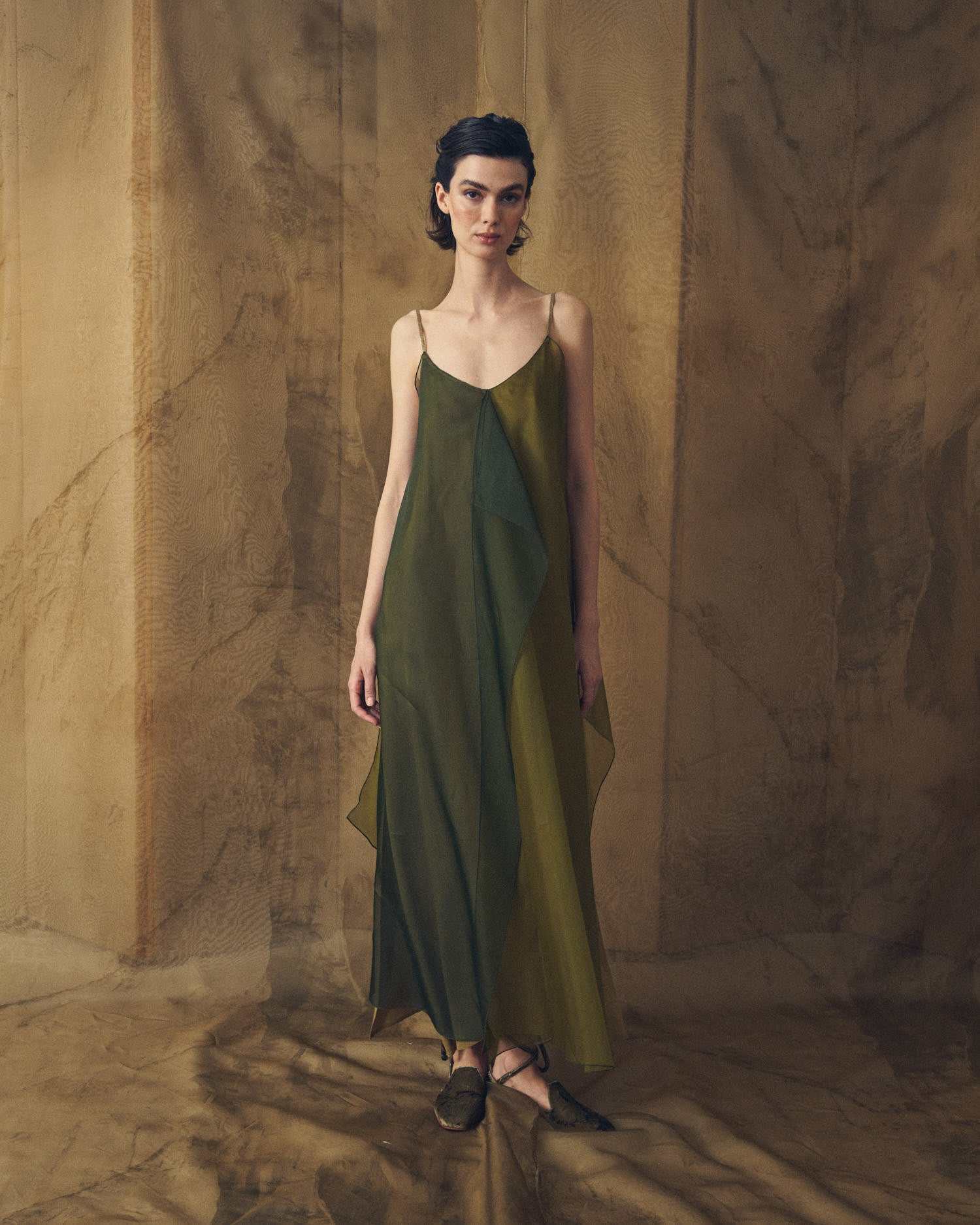 Full-length front studio view of model wearing the Panarea long organza strap dress in hunting green by T.ba