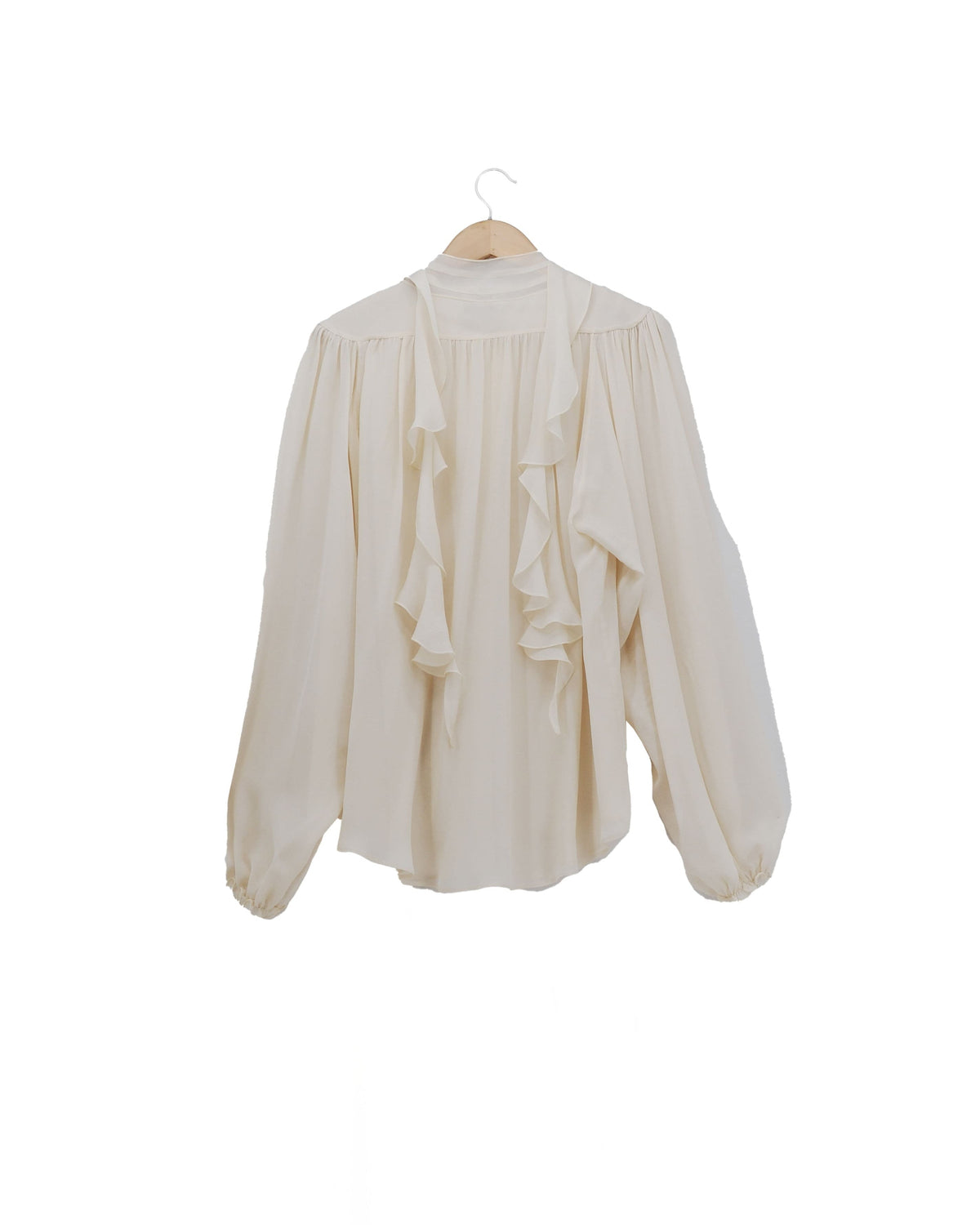 Back view of the Pienza blouse in fine crepe natural white crepon with a ruffled front panel, a bow at the neck, and puffed sleeves for women, T.ba