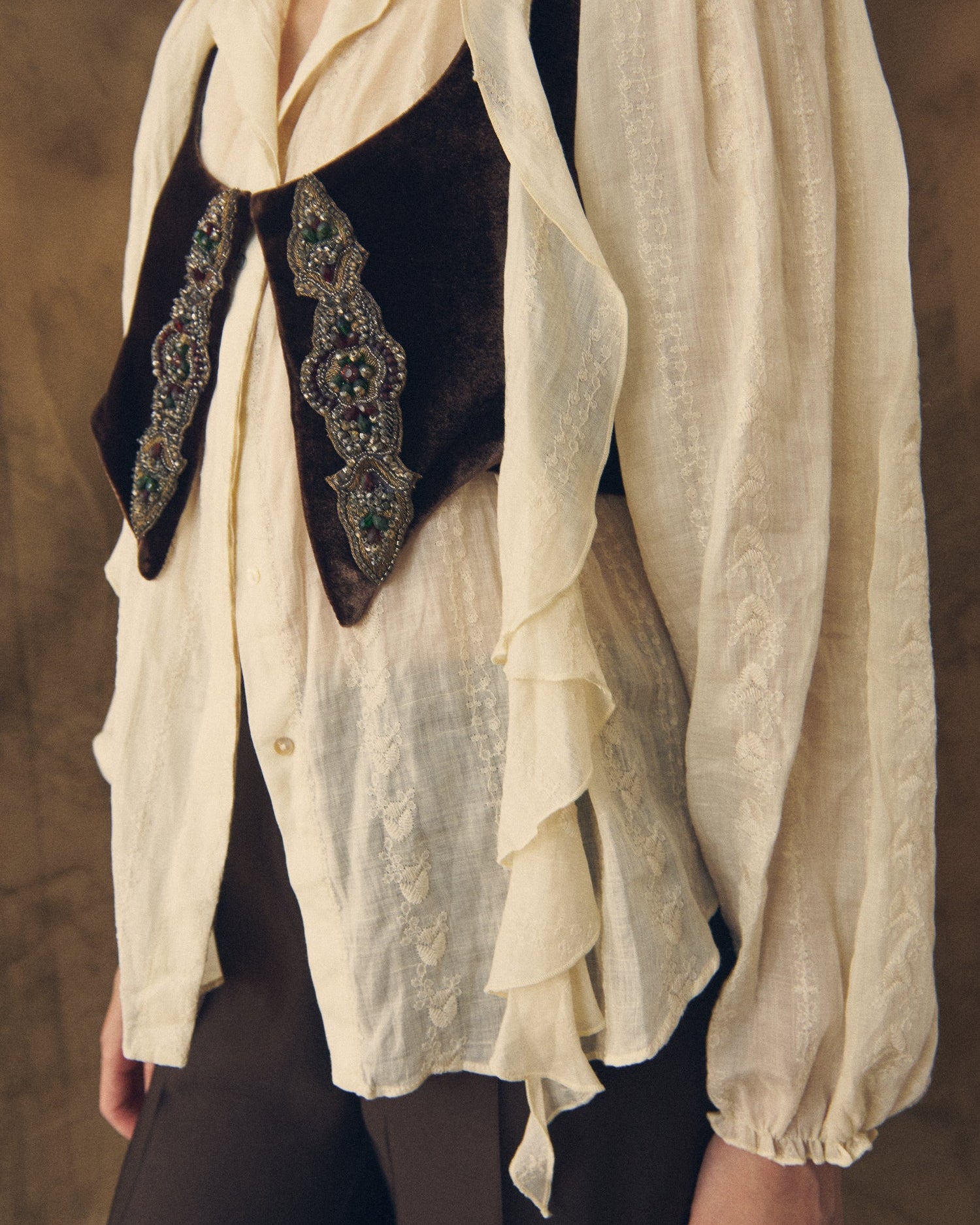 Close-up detail shot showcasing the delicate embroidery and ruffle trim of the Ramie Embroidered Pienza Blouse in natural for women by T.ba