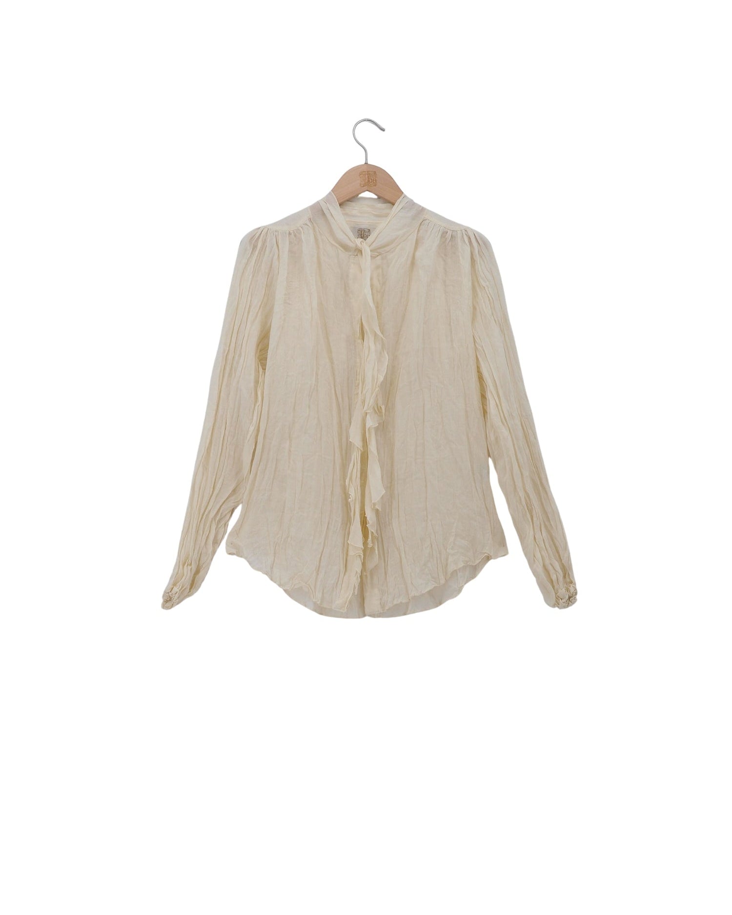 Women's embroidered natural off-white ramie Pienza blouse featuring raw-edge cascade ruffles, neck tie detail, and pleated long sleeves by T.ba