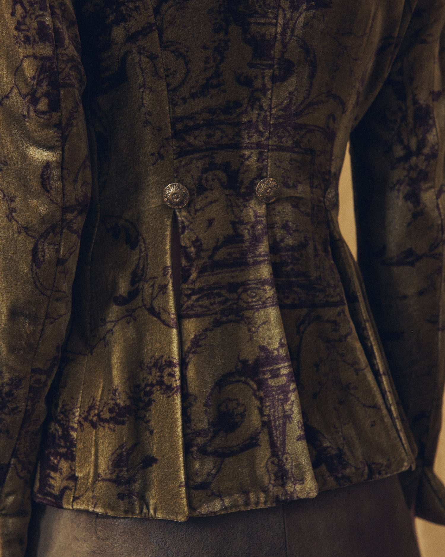 Close-up back detail of the Sam silk velvet jacket in print mocca highlighting structural pleats and ornate buttons by T.ba