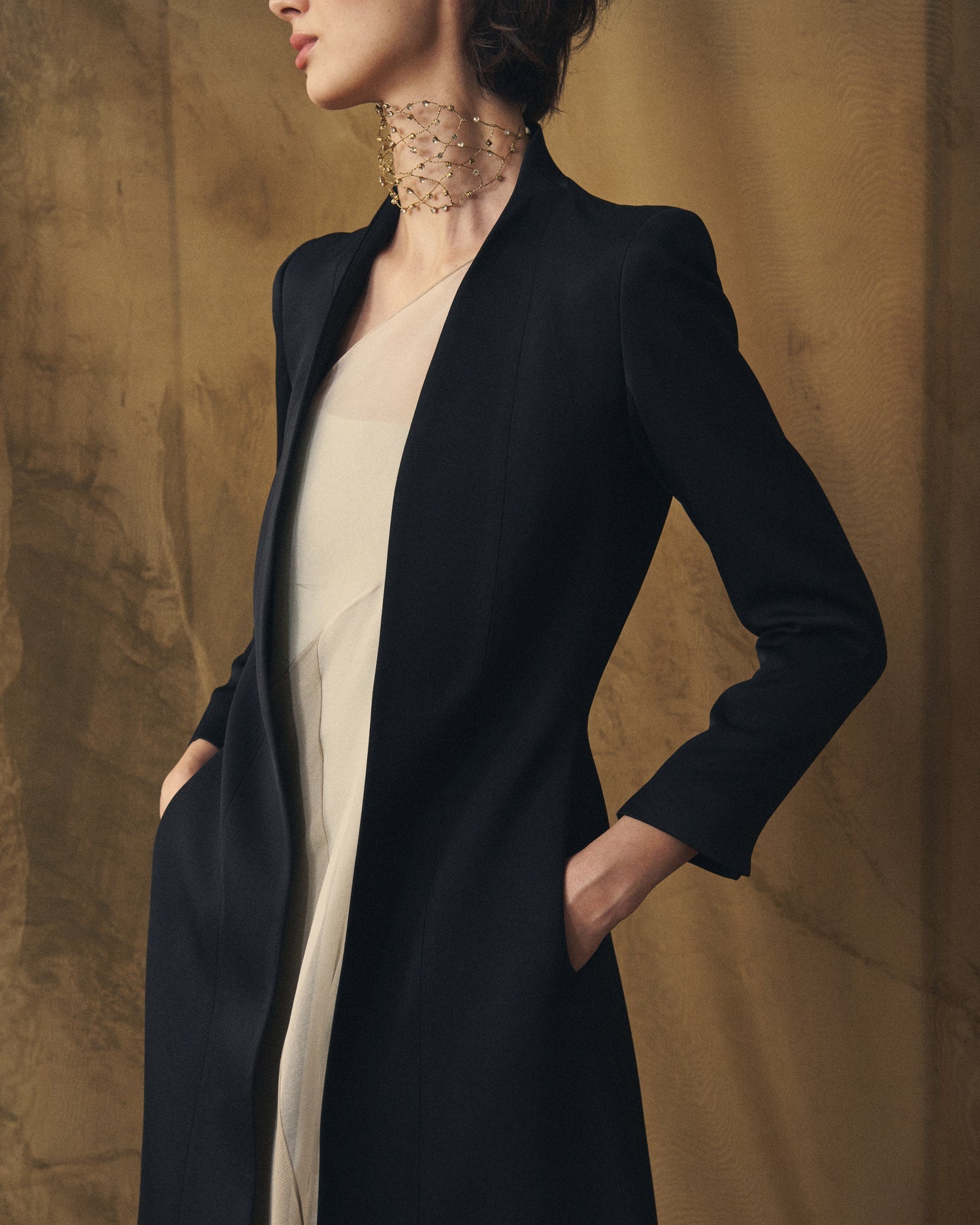 Close-up shot of women's Black Sharkskin Ginebra coat showing lapel detail and side pockets by T.ba