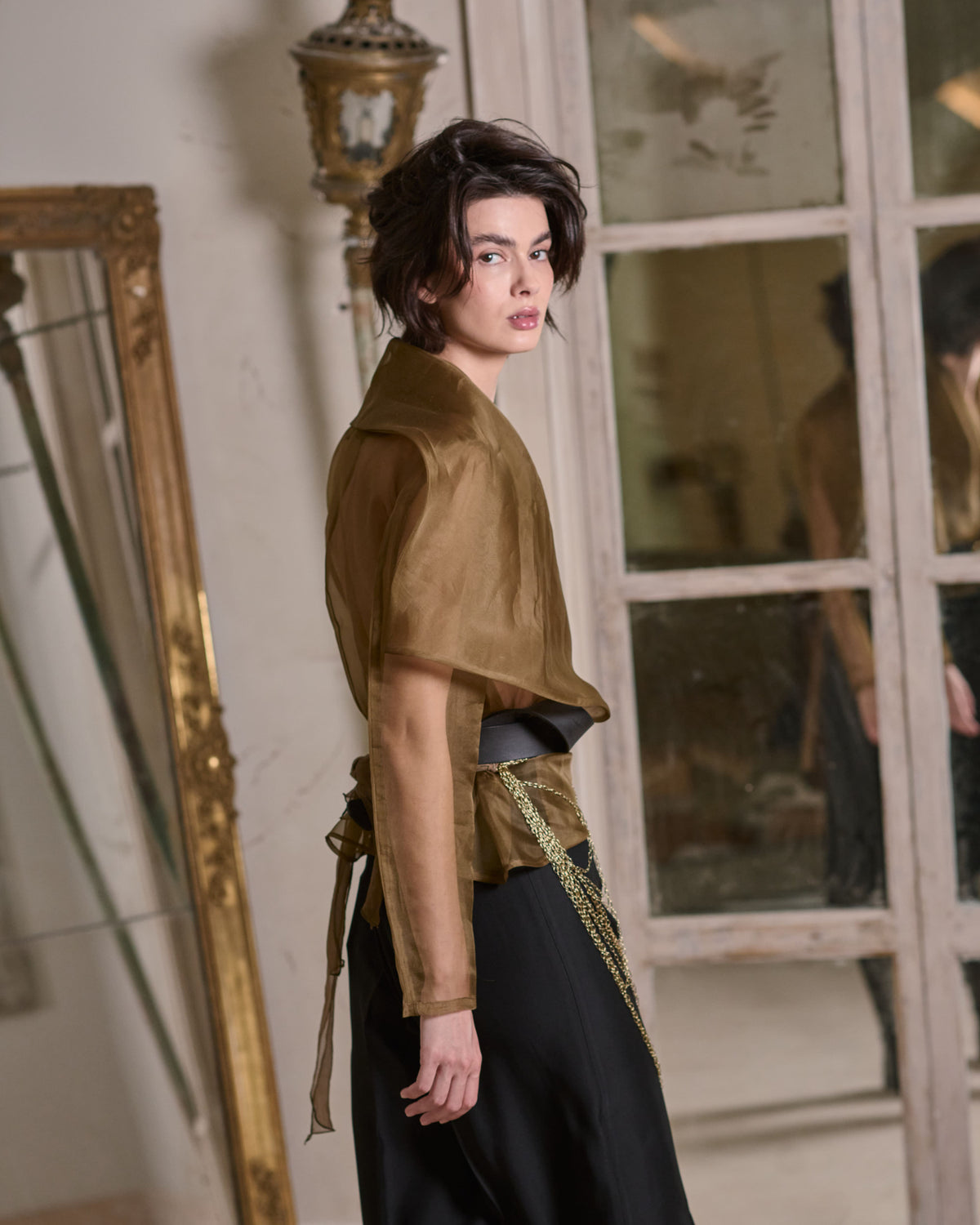 Side view of model wearing light translucent Organza Alina jacket in toffee showing back tie details for women T.ba