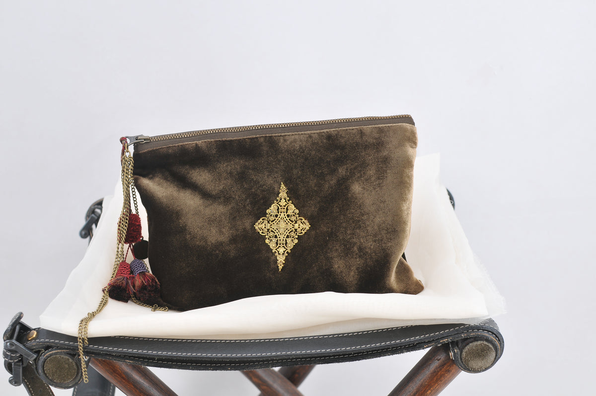 Front studio view of khaki green silk velvet Medallion pouch bag with gold embroidery and tassel details for women T.ba