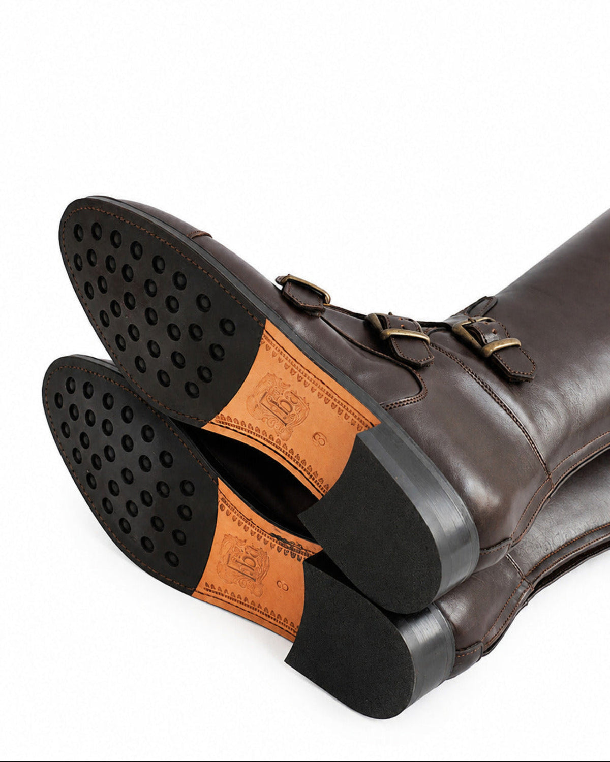 Bottom view showing rubber grip studded leather soles and engraved logo on chocolate riding boots T.ba
