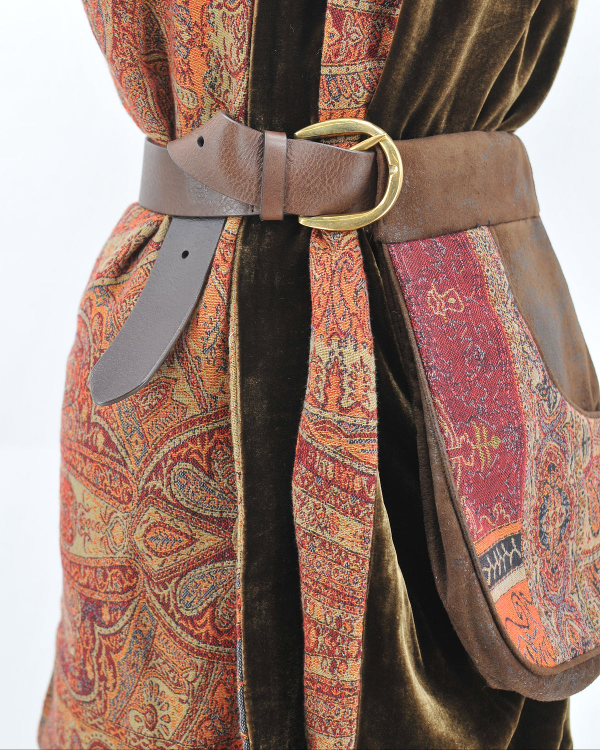Studio close-up shot of brown leather Duke pouch with brass buckle and patterned jacquard fabric panel T.ba