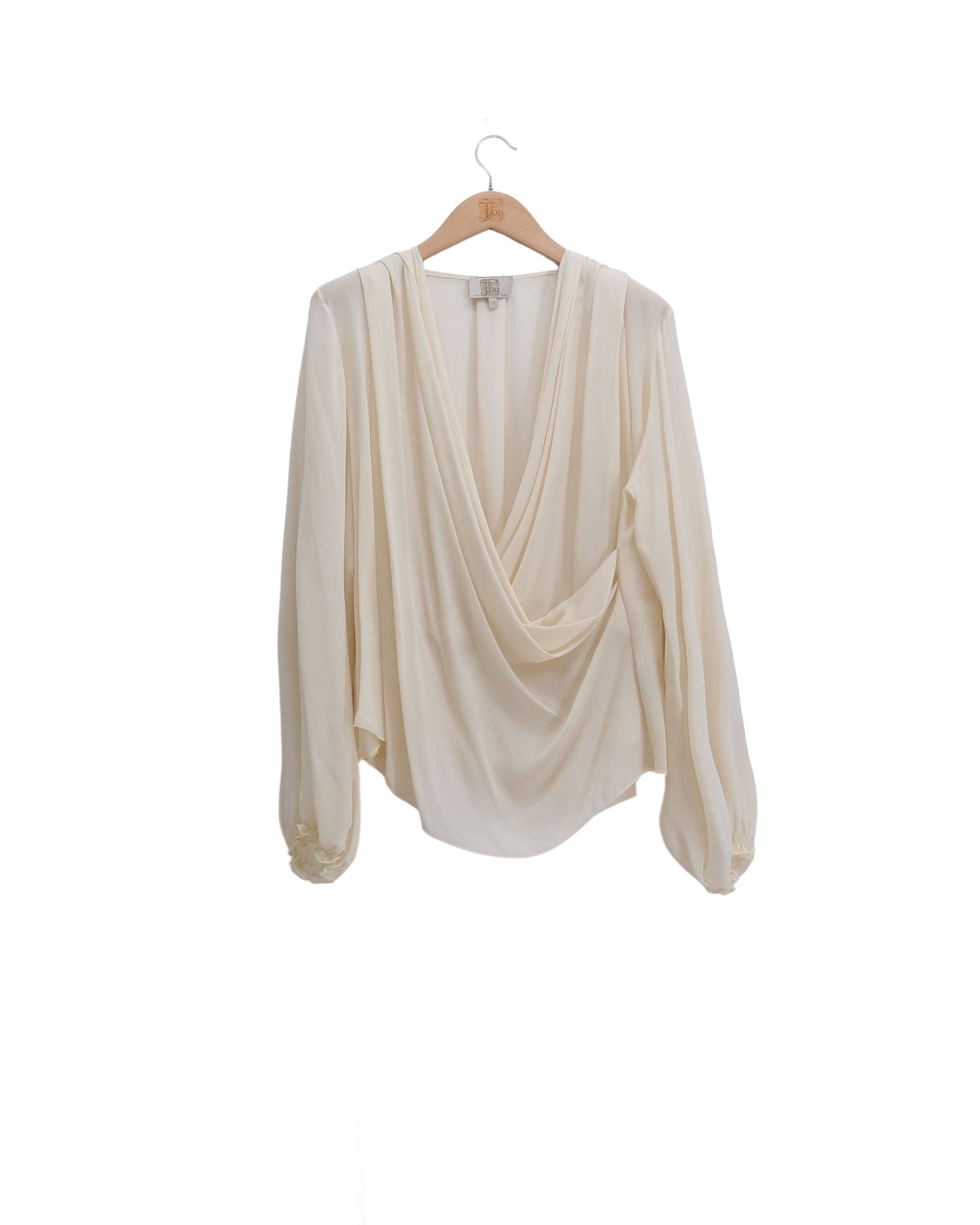 Women's fine crepe Toscana blouse in natural off-white featuring a draped crossover neckline and long puffed sleeves by T.ba