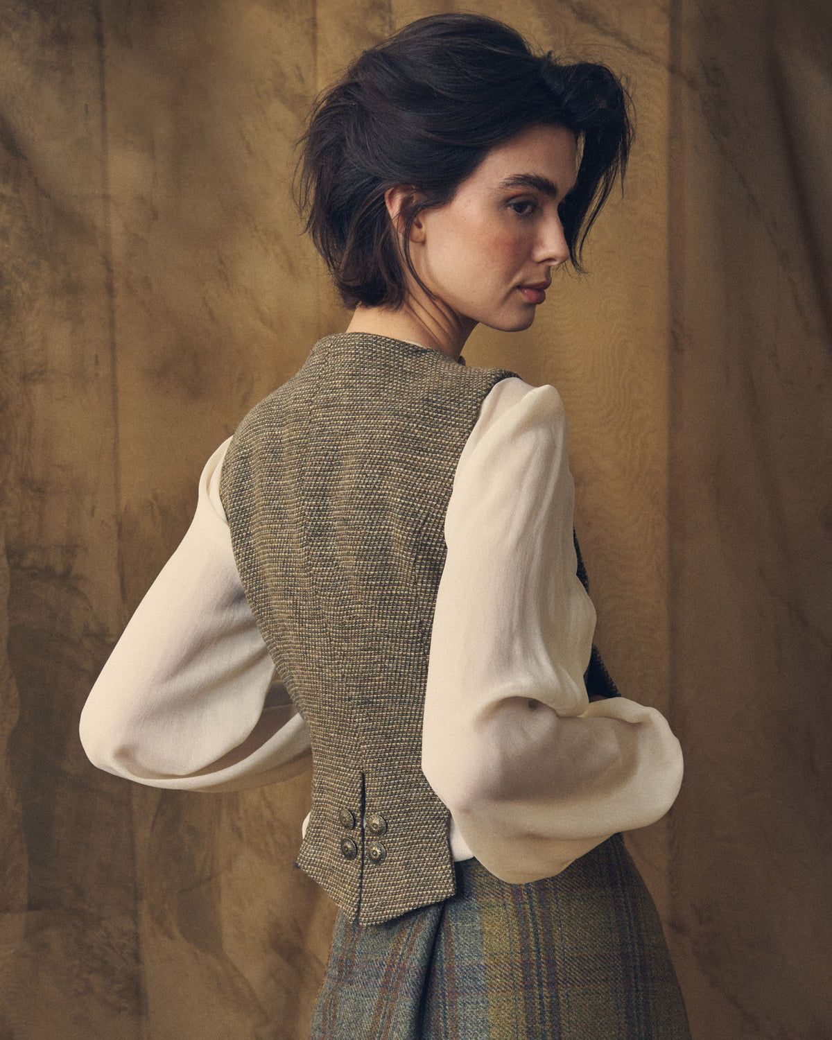 Back view of the Tweed Knit Baltea Vest showing the fitted waist and rear antique brass button details for women by T.ba.
