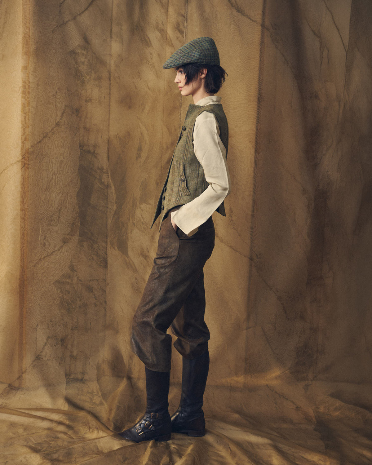 Side profile view of a model wearing the Tweed Short Baltea Vest paired with a cream blouse for women by T.ba.