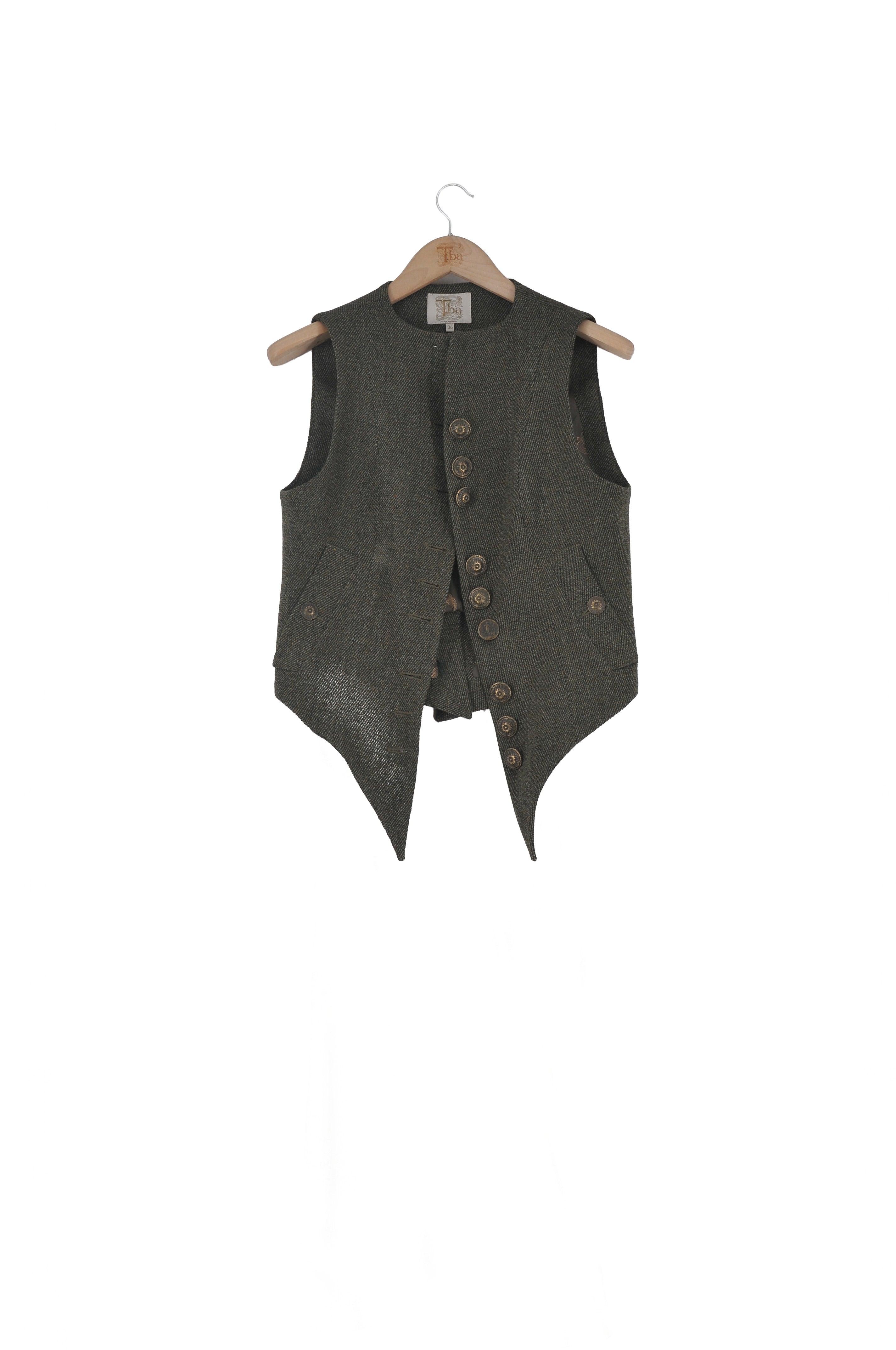 Front view of the Tweed Short Baltea Vest in slate green wool on a hanger showing the V-neck cut and asymmetric button line by T.ba.