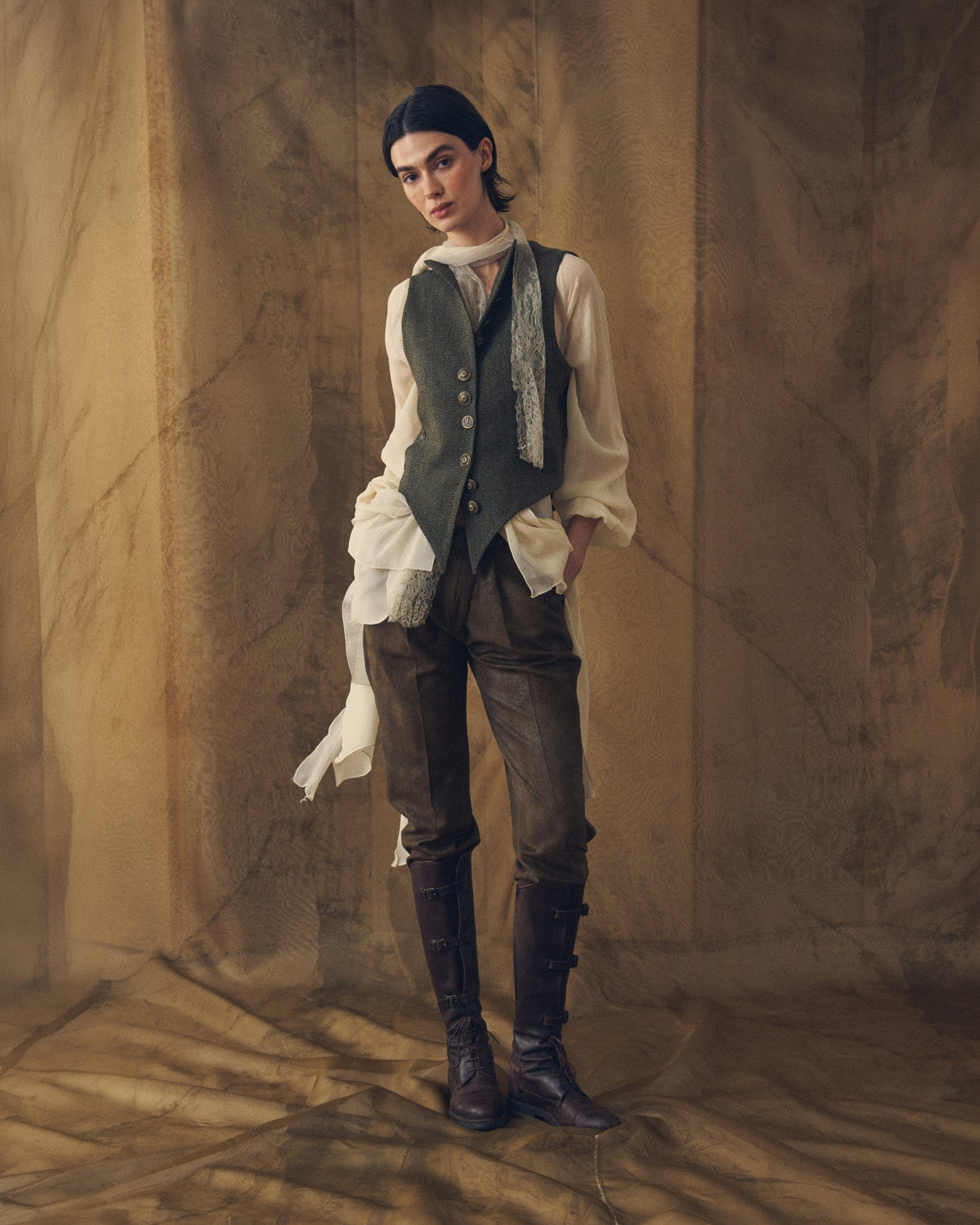 Front view of the Tweed Short Baltea Vest in slate green wool showing the single-breasted brass button closure by T.ba.