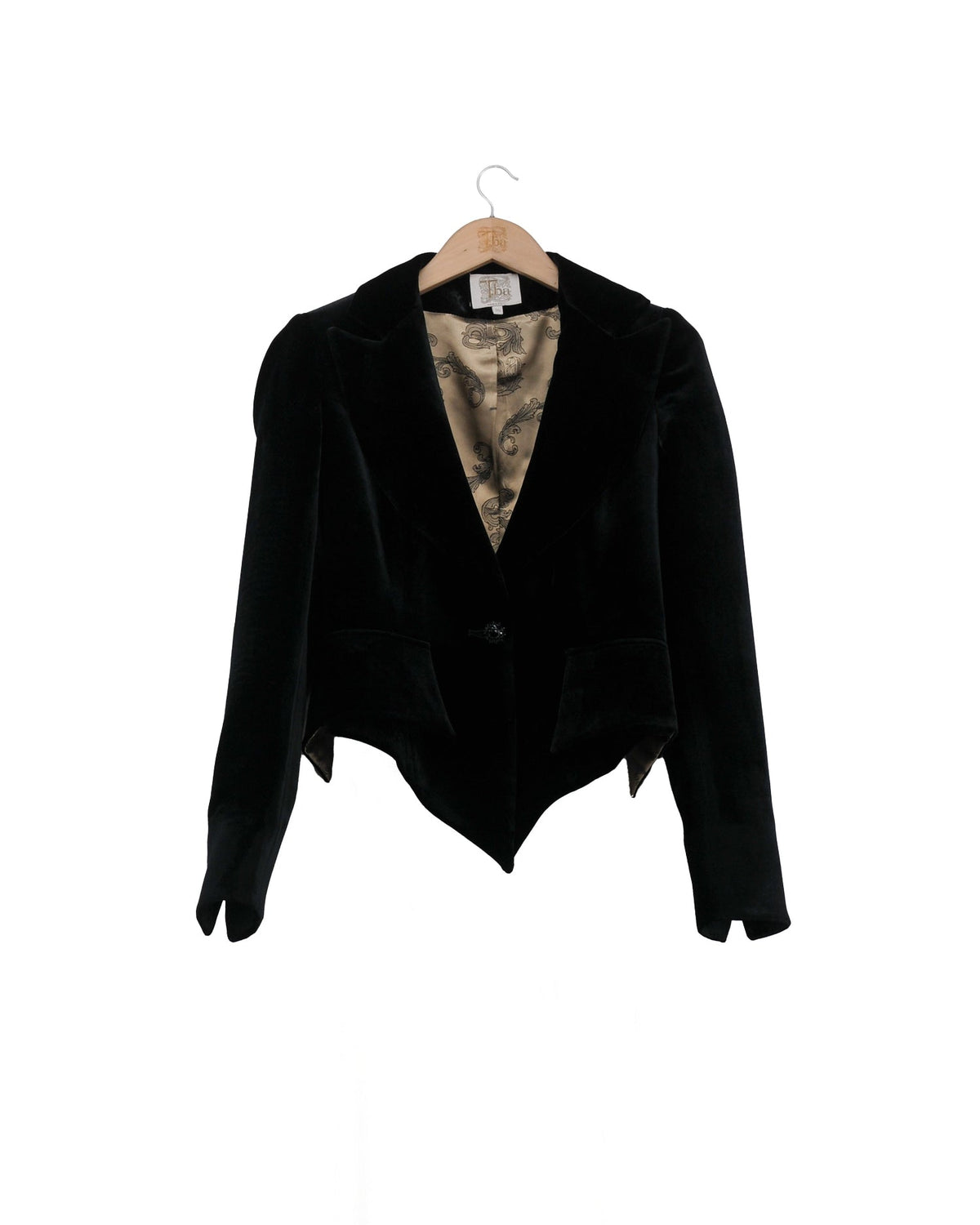 Front studio view on hanger of the short Verdi silk velvet jacket in black with pointed hem and printed lining by T.ba